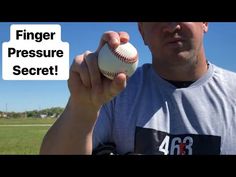 a man holding a baseball in his right hand with the words finger pressure secret on it