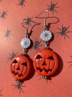 These Halloween earrings have a big orange pumpkin dangling from a creepy spiderweb charm! Spooky Orange Halloween Jewelry, Novelty Orange Earrings For Halloween, Orange Novelty Halloween Jewelry, Spooky Halloween Ear Wire Earrings, Halloween Spooky Ear Wire Earrings, Spooky Halloween Drop Earrings, Orange Dangle Earrings For Halloween, Spooky Nickel-free Earrings For Halloween, Spooky Dangle Earrings