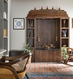 a living room filled with furniture next to a wall mounted bookcase and window sill