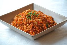 a white bowl filled with food on top of a table