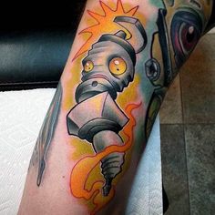 a man's leg with a cartoon character tattoo on it and an eyeball in the background