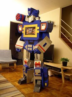 a robot made out of cardboard boxes in a living room