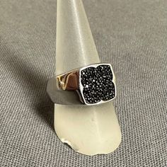 This is a Very Beautiful sterling silver ring w/ several small round cut Black Tourmaline! The stones are believed to be natural due to the variety of shades in color. They are arranged into a unique flower-like silhouette shape. The side of the band has a elegant arc going around it given a little extra dimension to the silver. Elegant statement piece is made by an unidentified jewelry artisan, but their custom stamp can be seen inside the band, as well as in a lovely cut-out design underneath Custom Stamp, Unique Flower, Be Natural, Ring Black, Unique Flowers, Cut Out Design, Multi Stone Ring, Black Tourmaline, Multi Stone