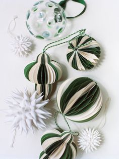 green and white paper decorations on a white surface