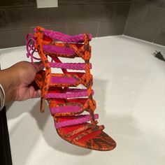 Create A Colorful Splash With This Strappy Python Tie-Back Sandal From B Brian Atwood. Python And Suede Upper. Open Toe; Tonal Topstitching. Braided And Intertwining Straps Form Vamp. Tie Closure At Back Of Ankle. Leather Lining And Sole. 3 1/4" Covered Heel. "Elisa" Is Imported. Orange Pink Color, Brian Atwood Shoes, Brian Atwood, Tie Backs, Orange Pink, Python, Pink Red, Pink And Orange, Open Toe