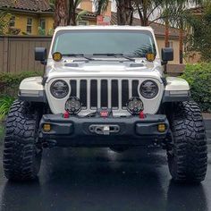 a white jeep is parked in the parking lot