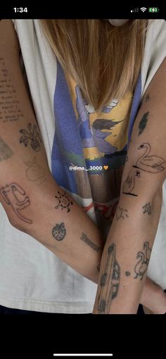 two people with tattoos on their arms