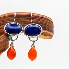 Handmade earrings crafted from sterling silver with teardrop-shaped 12x7mm micro-faceted Carnelian stones and beautiful oval 14x10mm Lapis Lazuli stones. This piece showcases a stunning combination of colors with two gorgeous stones. The total drop length is 40mm/1.57".  While we strive to make our products match the photos as closely as possible, please keep in mind that there may be slight variations. If you want to see more of our handmade earrings, please visit our Etsy shop at https://www.e Sterling Silver Natural Stones Teardrop Earrings, Sterling Silver Teardrop Earrings With Natural Stones, Earrings Boho Chic, Carnelian Earrings, Handcrafted Silver Jewelry, Boho Chic Earrings, Lapis Lazuli Earrings, Wedding Ring Necklaces, Rock Jewelry