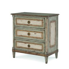 an old dresser with three drawers and gold trimmings on the top, against a white background