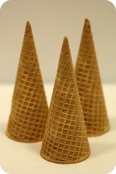 three cones made out of cardboard sitting on a table