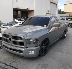 a gray truck parked in front of a building