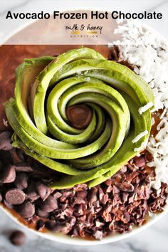 avocado frozen hot chocolate is in a bowl with white rice and chocolate chips