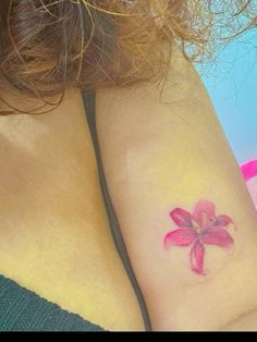 two women with tattoos on their arms and one has a flower tattoo on her arm