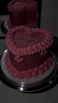 two heart shaped cakes sitting on top of a table