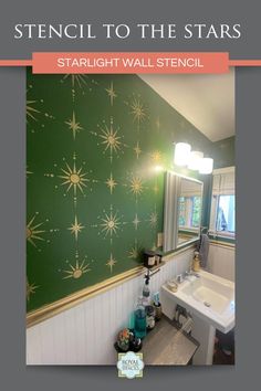 a bathroom with stars painted on the wall next to a white sink and counter top