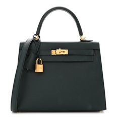 This is the authentic HERMES Epsom Kelly Sellier 25 in Vert Cypress. This classic Kelly handbag tote is crafted of luxuriously textured calfskin leather in dark green. The bag features a rolled leather top handle, an optional shoulder strap, and a crossover flap and strap closure with gold plated hardware including a padlock and a clochette for the keys. This opens to a matching leather interior with zippered and flat pockets. Kelly Handbag, Kelly Sellier, Dream Bags, The Keys, Leather Interior, Leather Top, Tote Handbags, Crossover, Top Handle