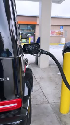 an electric car is being charged at a gas station