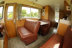 the inside of an rv with leather couches