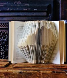 an open book sitting on top of a wooden table