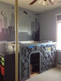 a bedroom with batman themed bedding in the corner