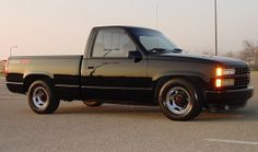 a black pickup truck parked in a parking lot