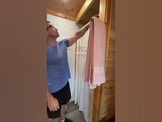 a man is hanging out his clothes in the closet