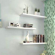 two white shelves with books and pictures on them