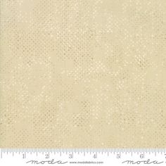 a white fabric with small dots on it, and a ruler in front of it