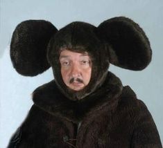 a man wearing a bear costume with ears on his head