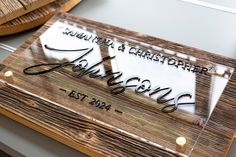 a glass plaque with the name and date on it sitting on top of a table