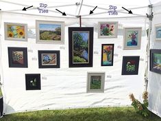 a white tent with pictures on it and arrows pointing to the different types of paintings