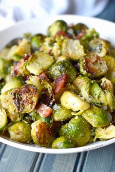 a white bowl filled with brussel sprouts and bacon