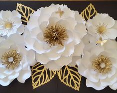 white flowers with gold leaves on a black background