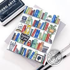 there is a card with some books on it and a pen next to it that says hero arts