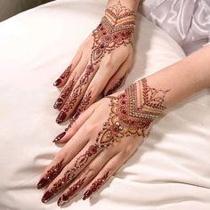 a woman's hands with hennap on top of her arm and hand