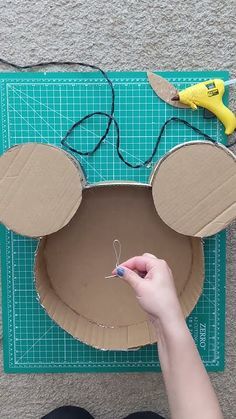 someone is making a cardboard mouse head