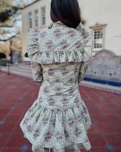 Saddle up in style with the Quinlynn Taupe Floral Ruffle Bow Dress. This versatile dress is perfect for any occasion, whether you're hitting the rodeo in your cowgirl boots or stepping out in the spring sun with wedges. With its playful ruffle and bow details, you'll be the talk of the town. Giddy up and grab yours today! Product Details: Features: Adjustable bow tie. Ruffle details. Side zipper closure. Fit: True to size. Model is 5'3 and wearing a size small. Fabric: 100% cotton; Lining- 100% polyester Care: Dry clean SIZING DETAILS: There is not a universal size chart that will apply to every item and person because each item runs differently. Please pay special attention to the product description where sizing is noted: true to size, runs large, or runs small. If you have any questions Fitted Dresses With Ruffle Hem For Day Out, Summer Ruffle Dress With Ruffled Hem And Collar, Spring Fitted Dress With Ruffle Hem, Fitted Spring Dress With Ruffle Hem, Chic Summer Ruffle Dress With Ruffled Collar, Chic Spring Ruffle Dress For Daywear, Fitted Ruffled Skirt Dresses For Daywear, Casual Fitted Ruffle Dress With Ruffle Hem, Fitted Mini Dress With Ruffles For Garden Party