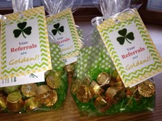 three bags filled with gold and green candy