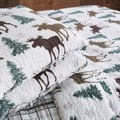 the bedding is made up with moose and pine trees