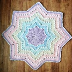 a crocheted doily on a wooden floor with a wood floor in the background