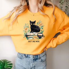 Cozy 'Just One More Cat Mama Sweatshirt' with trendy design and retro librarian charm. Perfect for college, garden reading, or alone time. Ideal gift for book lovers and reading teachers. #CatMama #BookLover #CozyStyle #VSCOFashion Best Friend School, Reading Teacher Gifts, Vsco Shirts, Fall Picnic, Comfy Crewneck, Plant Mama, Just One More Chapter, Librarian Shirt, Cat Mama