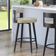 two bar stools sitting in front of a counter