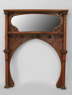 an ornate wooden shelf with mirror above it