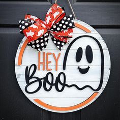 a halloween door hanger that says hey boo with a ghost face and polka dot bow