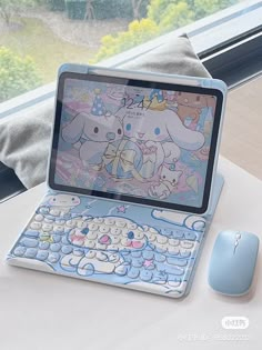 an open laptop computer sitting on top of a table next to a mouse and keyboard