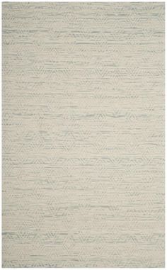 a white rug with an abstract design on the bottom, and light green trimmings