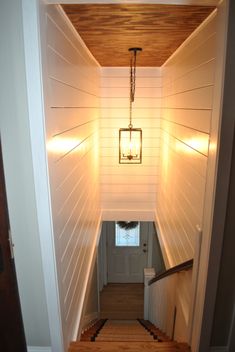 the light is on at the top of the stairs leading up to the second floor