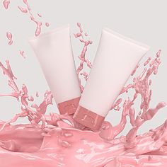 two tubes of pink liquid splashing out of them