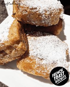 powdered sugar covered pastries on a white plate