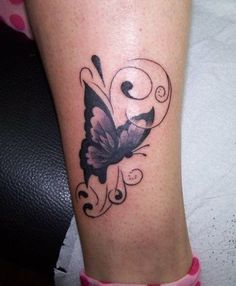 a woman's leg with a butterfly tattoo on it